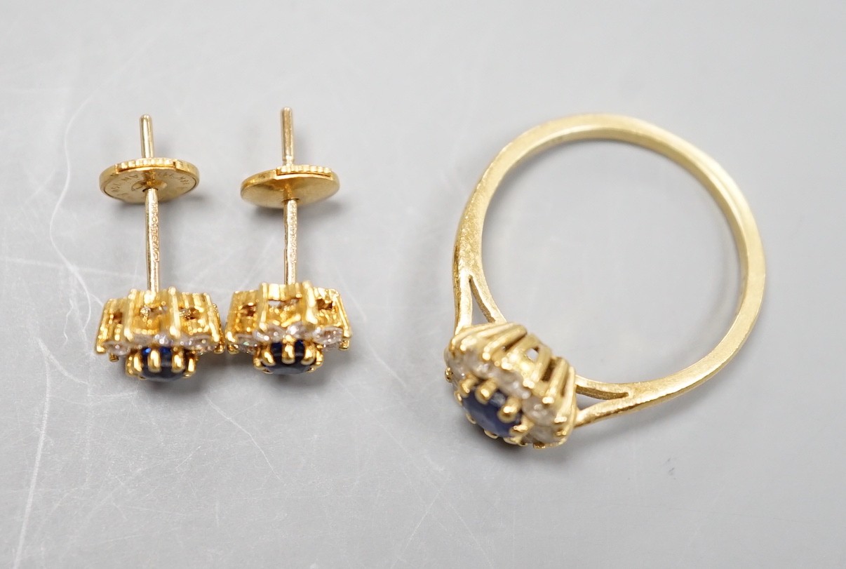 A modern 18ct gold, sapphire and diamond set circular cluster ring, size L and a pair of matching earrings, gross weight 4.6 grams.